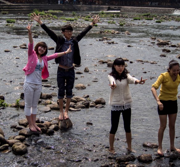 Chinese tourists getting their feet wet.