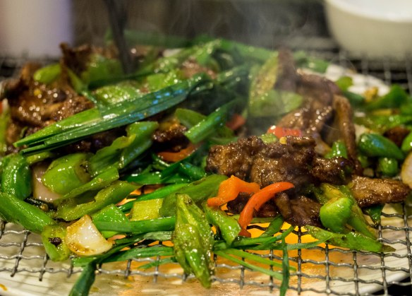Tender beef and vegetables served over a flame.